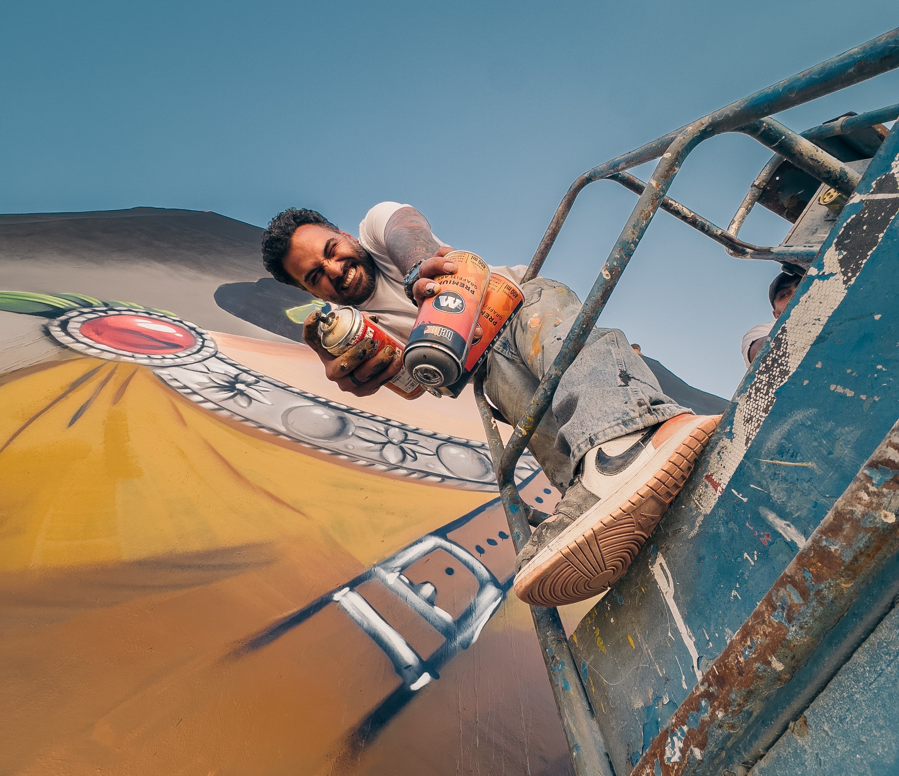 Suhaib Attar painting a mural